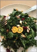  ?? PHOTO BY CATHY THOMAS ?? This kale salad is enlivened with dates, dried cranberrie­s, maple syrup and crunchy toasted almonds.