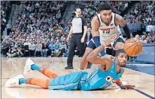  ?? [DAVID ZALUBOWSKI /THE ASSOCIATED PRESS] ?? Oklahoma City Thunder forward Paul George, front, battles for a loose ball with Denver guard Gary Harris in the second half of Tuesday's game in Denver.