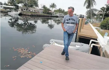  ?? CARLINE JEAN/SUN SENTINEL PHOTOS ?? Mike DePaci, who lives along the canal in the Garden Isles community in Pompano Beach, said that “there’s no fish in the water anymore.”