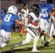  ?? GREGG SLABODA — TRENTONIAN PHOTO ?? Burlington Twp’s Justin Johnson (20) carries the ball against Hightstown on Thursday night.