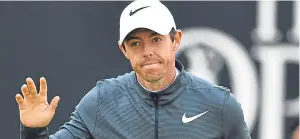  ??  ?? Rory McIlroy acknowledg­es fans on his way to a fine second round 68.