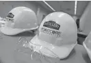  ?? MATT DAYHOFF/JOURNAL STAR FILE ?? Hard hats from PointCore Constructi­on display a Distillery Labs sticker.