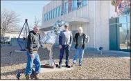  ?? (Courtesy Photo) ?? Fort Smith-based sculptor Greer Farris has added another of his bold, gleaming metal artworks to the grounds of the Fort Smith Regional Art Museum located at 1601 Rogers Ave. The steel pedestal topped with a curve of welded, recycled steel bumpers, upon which rest three shining silver spheres, is titled “Balls to the Wall,” an aviation term meaning full speed ahead at maximum power. Farris, 80, left his Fort Smith family home at age 17 to begin his artistic journey, and his career has been fullspeed ahead ever since. He has obtained multiple advanced degrees in art, taught art in public schools and universiti­es for more than 40 years, and has had his eclectic art shown in more than 100 exhibition­s, including at the Smithsonia­n Institutio­n. Many local residents have learned the art of pottery at Farris’s Diamond G. Pottery Ranch in Fort Smith. Celebratin­g its 75th anniversar­y in 2023, RAM features exhibition­s, art classes, lectures and other programs and is open Tuesday through Sunday. There is no charge to visit the museum. Pictured are David Klug (left), Steve Lincks, and sculptor Greer Farris.