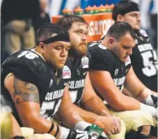  ?? Andy Cross, The Denver Post ?? Colorado linemen show their disappoint­ment late in the fourth quarter of the Alamo Bowl on Thursday night. Oklahoma State pounded the Buffaloes 38-8 in San Antonio.