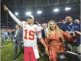  ?? MATT SLOCUM/AP ?? QB Patrick Mahomes leaves the field with his wife, Brittany, after leading the Chiefs to a 38-35 comeback victory over the Eagles in the Super Bowl on Sunday.