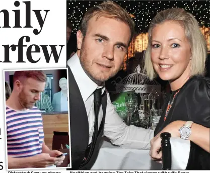  ??  ?? Distracted: Gary on phone Healthier and happier: The Take That singer with wife Dawn