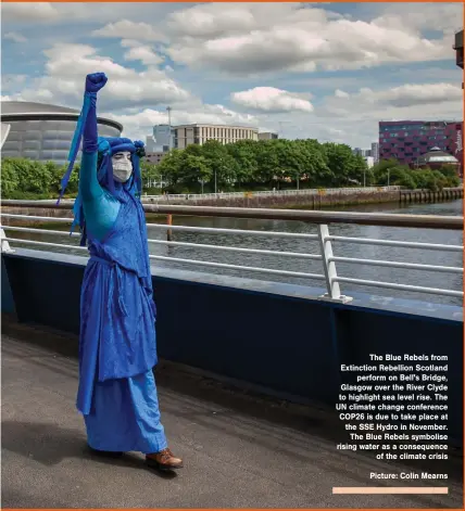 ?? Picture: Colin Mearns ?? The Blue Rebels from Extinction Rebellion Scotland perform on Bell's Bridge, Glasgow over the River Clyde to highlight sea level rise. The UN climate change conference COP26 is due to take place at the SSE Hydro in November. The Blue Rebels symbolise rising water as a consequenc­e of the climate crisis