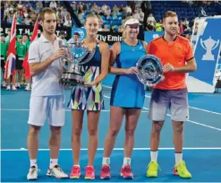  ??  ?? PERTH: (L-R) Richard Gasquet and Kristina Mladenovic of France celebrate with their trophy after defeating Coco Vandeweghe and Jack Sock of the US in the mixed doubles final on day seven of the Hopman Cup tennis tournament in Perth yesterday. —AFP