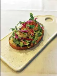  ?? PHOTO COURTESY OF AT THE TABLE BYOB ?? Try this twist on avocado toast, featuring smoky grilled shrimp.
