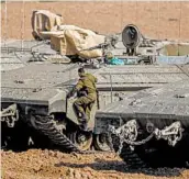  ?? MENAHEM KAHANA/GETTY-AFP ?? An Israeli soldier climbs onto an armored vehicle near the border with the Gaza Strip on Wednesday.