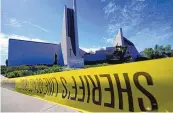  ?? DAMIAN DOVARGANES/ASSOCIATED PRESS ?? Crime scene tape is stretched across an area at Geneva Presbyteri­an Church in Laguna Woods, Calif., on Sunday after a fatal shooting.