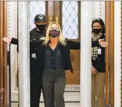  ?? Chip Somodevill­a Getty I mages ?? U. S. CAPITOL POLICE check Rep. Marjorie Taylor Greene ( R- Ga.) after she set off a metal detector.