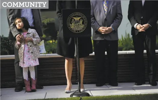  ?? Lea Suzuki / The Chronicle 2015 ?? Zahra Sayed (left) stands with her father during the opening ceremony for the 1400 Mission housing project in 2015.