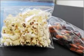  ?? MICHILEA PATTERSON — DIGITAL FIRST MEDIA ?? Air-popped popcorn and trail mix are healthy snack options for packed school lunches. To save time, divide the snacks into individual bags or containers over the weekend.