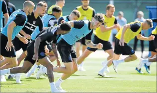  ?? Picture: AFP ?? STEADY DOES IT: England defender Gary Cahill, centre, runs with teammates during a training session. Cahill has warned England against looking too far ahead in Russia