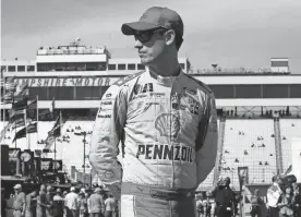  ?? CHARLES KRUPA/AP ?? Joey Logano walks through the garage area prior to practice for the NASCAR Cup Series 300 auto race at New Hampshire Motor Speedway in Loudon, N.H., on Saturday.