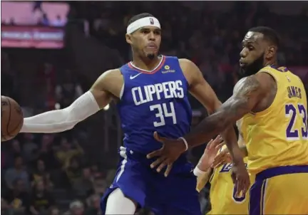  ?? MARK J. TERRILL — ASSOCIATED PRESS FILE ?? Clippers forward Tobias Harris, left, passes the ball as Lakers forward LeBron James defends during a Jan. 31 game in Los Angeles. Harris was traded Wednesday to the 76ers.