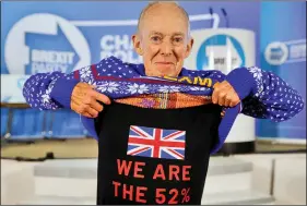  ?? REUTERS ?? Brexit Party supporter Barry Clarkson, 79, lifts his Christmas jumper to show his T-shirt displaying a pro-brexit slogan, before party leader Nigel Farage arrives to speak during a visit to Buckley, Britain, on 2 December.