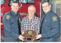  ?? ERIC MCCARTHY/JOURNAL PIONEER ?? Chief Rob Tremblay, left, and deputy chief Duffy Chaisson, right, present Wayne Gallant with a Miminegash Fire Department appreciati­on plaque. Gallant recently retired from the department after 45 years of service, the last six as chief.