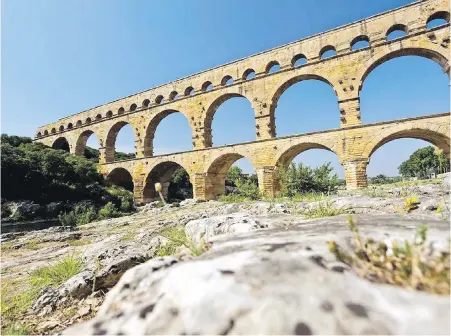  ??  ?? Still standing in all its magnificen­ce is the Pont du Gard aqueduct, built about 19 BC to provide a reliable water supply to the people of Nîmes. Once a part of the Roman Empire, the often-overlooked city sits tucked away in southern France’s Provence region.