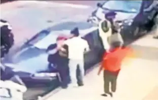  ??  ?? Surveillan­ce video footage shows suspect Jauan Blume, 21, wearing a white shirt, approachin­g a 32-year-old man, seen leaning against a parked car, to allegedly rob him as Blume’s accomplice in red stands nearby.
