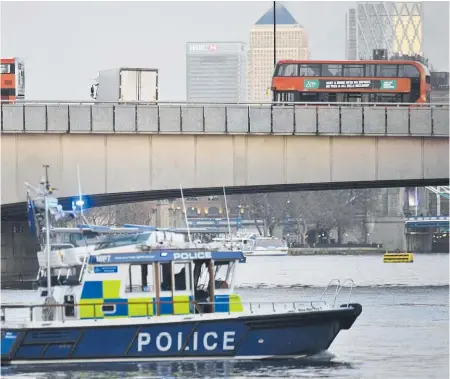  ?? Photos / AP ?? A police boat patrols the River Thames near London Bridge after the attack, main pic. Bottom, from left: A bystander holds a knife taken from the offender, the offender surrounded by police, police on Cannon St respond to the incident.