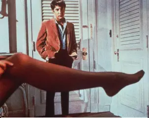  ??  ?? Dustin Hoffman looks at the stockinged leg of Anne Bancroft in the 1967 film The Graduate. This month marks 80 years of nylon stockings. Photo: AP