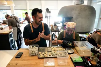  ?? HELEN H. RICHARDSON — THE DENVER POST ?? Former Brutø executive chef and owner Michael Diaz de Leon, center, pastry chef Yna Zuniga, right, have a laugh together as they prepare house-made masa balls for tortillas at Brutø in Denver on Sept. 13, 2023.