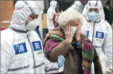  ?? XIONG QI/XINHUA/ZUMA PRESS ?? A cured coronaviru­s patient sheds tears as she walks out of a rehabilita­tion center after a 14-day quarantine for medical observatio­n on March 10 in Wuhan, central China’s Hubei Province.