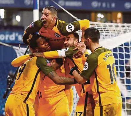  ?? REUTERS PIC ?? Brighton’s Glenn Murray (top) and teammates celebrate their third goal against West Brom in a FA Cup fourth round replay at The Hawthorns on Wednesday.