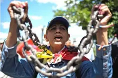  ??  ?? An opposition activist takes part in a rally, in Caracas, in support of Requesens, who was seized by intelligen­ce officers at his home. — AFP photo