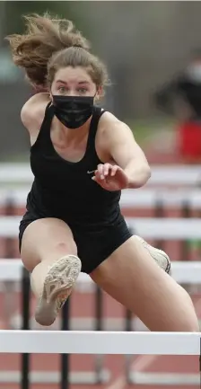  ?? PAUL CONNORS pHOTOS / BOSTON HERALD ?? EYES ON THE PRIZE: Paige Murphy of Billerica clears a hurdle on her way to a win during the MSTCA In Vacational Meet in West Bridgewate­r on Saturday. Murphy also took the top spot in the long jump.