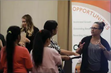  ?? MARCIO JOSE SANCHEZ — THE ASSOCIATED PRESS ?? Kathy Tringali, right, a recruiter for retailer Big 5 Sporting Goods, talks to job seekers during a job fair in San Jose On Friday the U.S. government issues the August jobs report.