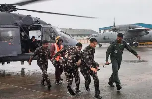  ?? PTI ?? Rescued fisherman being brought to Kerala coast by Indain Navy personnel in Kochi on Saturday. —