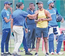  ?? — AP ?? (from left) Former India cricketer Rahul Dravid interacts with Shikhar Dhawan during a training session in Bengaluru on Friday.