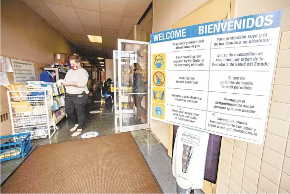  ?? APRIL GAMIZ/THE MORNING CALL ?? A sanitizing station is seen at an entrance during a tour at Dodd Elementary School in Allentown. Principal Katrina Griffin is seen in the background.