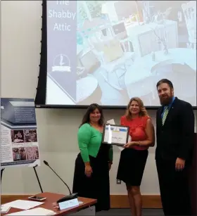  ?? DAN SOKIL - MEDIANEWS GROUP ?? Karin Wolfle, owner of The Shabby Attic in Lansdale, receives the borough’s Business of the Month award from Economic Developmen­t Committee chairwoman Carrie Hawkins Charlton, left, and member BJ Breish during the July 17, 2019 council meeting.