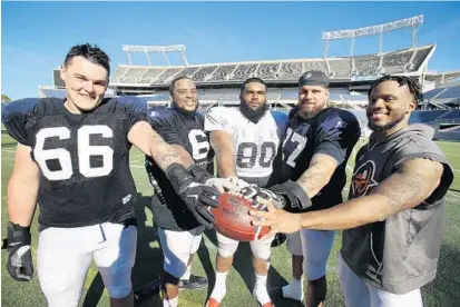  ?? STEPHEN M. DOWELL/ORLANDO SENTINEL ?? The Orlando Apollos’ roster will include five former UCF players, from left to right: Aaron Evans, Jordan McCray, Antonio Guerad, Chris Martin and Rannell Hall. They will return to Spectrum Stadium on Saturday for their Alliance of American Football debut against the Atlanta Legends.