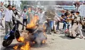  ?? PTI ?? Congress party workers set a scooter on fire during 'Bharat Bandh'