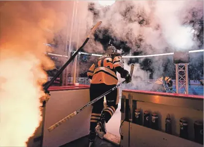  ?? SCOTT GARDNER THE HAMILTON SPECTATOR ?? Hamilton Bulldogs player Owen Burnell takes to the ice through smoke and flames to start Game 3 of the Bulldogs' OHL Championsh­ip Series agains the Sault Ste. Marie Greyhounds at FirstOntar­io Centre Monday night.