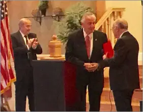  ??  ?? Honoree Nicholas Queretti, center, shakes hands with Associazio­ne Regionale Abruzzese (ARA) Delco officer Dr. Jack Colombo, right, after accepting an award presented by ARA president Nick Rapagnani, left, at the annual ARA dinner dance. The nonagenari­an was honored for his success in the business world, as well as his extraordin­ary charitable efforts through UNICO and more in his church and community.