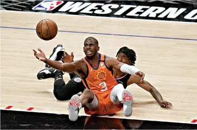  ?? AP Photo/Jae C. Hong ?? ■ Phoenix Suns’ Chris Paul retrieves the ball against Los Angeles Clippers’ Terance Mann during Game 6 of the Western Conference Finals on Wednesday in Los Angeles.