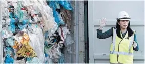  ?? VINCENT THIAN/AP ?? Environmen­t Minister Yeo Bee Yin shows a shipment of plastic waste May 28 in Port Klang, Malaysia. Some of the non-recyclable garbage came from the United States.