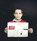  ??  ?? 12-year-old Sami Abdullah shows the picture he painted.