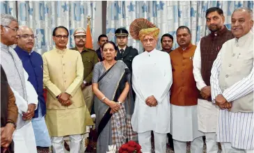  ?? PTI ?? SWORN IN
The new inductees with CM Chouhan and Governor Anandiben Patel