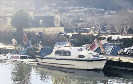  ??  ?? Parts are strewn by the canal towpath and, below, one of the boats is now almost fully submerged after sinking