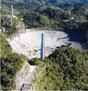  ?? AFP/Getty Images ?? This aerial view shows the damage at the Arecibo Observator­y after the platform collapsed.