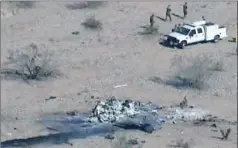  ?? Gannett ?? Two helicopter­s collided: Officials investigat­e the scene of an air crash Thursday near Yuma, Ariz. Seven Marines were killed in the training accident.