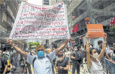  ?? AFP ?? Protesters display banners during a rally against a new national security law in Hong Kong yesterday.