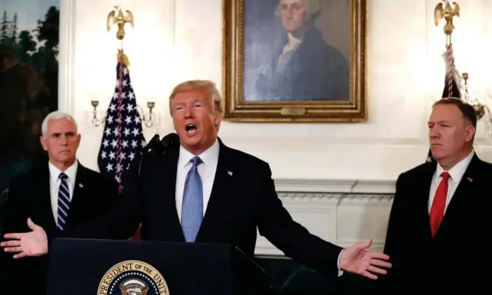  ?? Photograph: Mark Wilson/Getty Images ?? Donald Trump is flanked by Vice-President Mike Pence, left and the secretary of state, Mike Pompeo, while announcing the lifting of sanctions on Turkey at the White House.